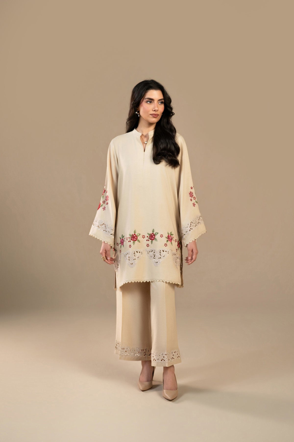 A woman wearing the Ivory Rouge Karandi Set, a beige embroidered kurta with matching culottes